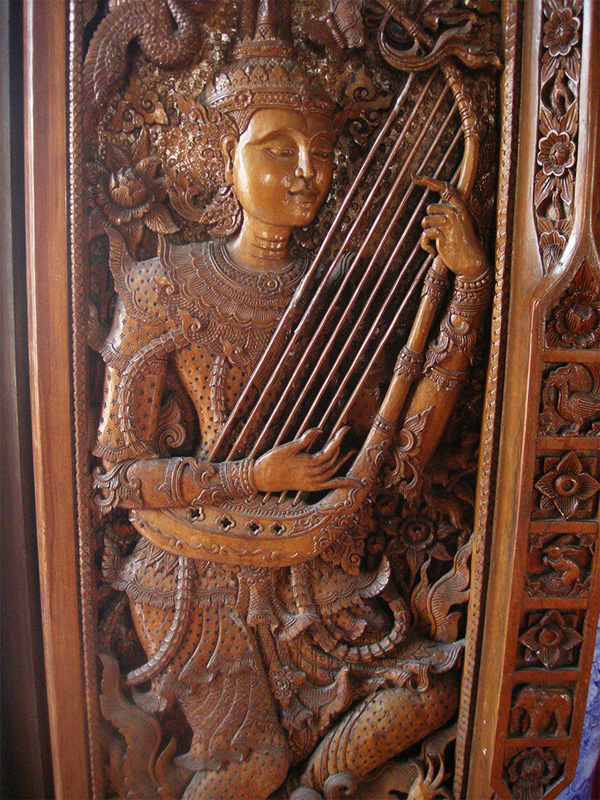 Traditional Thai wood carving of a musician