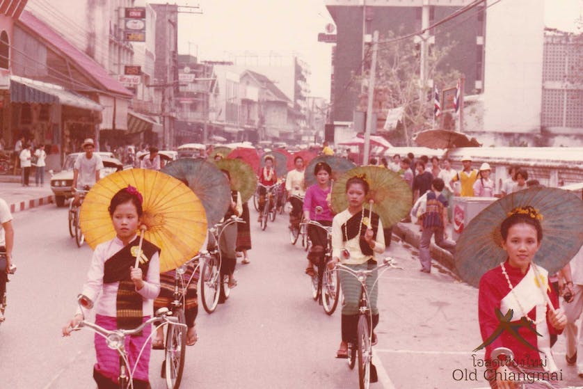 Borsang Umbrella ladies riding bikes through Chiang Mai 1970s